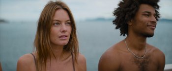 Movie still from “No Limit” (2022), directed by David M. Rosenthal – A woman standing next to a man on the beach; Close Up shot, Low angle