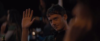 Movie still from “No Limit” (2022), directed by David M. Rosenthal – A person waving at the camera; Close Up shot, Over the shoulder angle