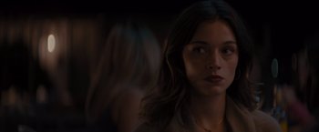 Movie still from “No Limit” (2022), directed by David M. Rosenthal – A young woman with long brown hair stares into the distance; Close Up shot, Over the shoulder angle