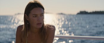 Movie still from “No Limit” (2022), directed by David M. Rosenthal – A beautiful young woman sitting on top of a boat; Close Up shot, Over the shoulder angle