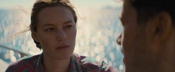 Movie still from “No Limit” (2022), directed by David M. Rosenthal – A woman sitting next to a man in front of a body of water; Close Up shot, Over the shoulder angle