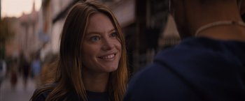 Movie still from “No Limit” (2022), directed by David M. Rosenthal – A woman smiles brightly while talking to a man; Close Up shot, Over the shoulder angle