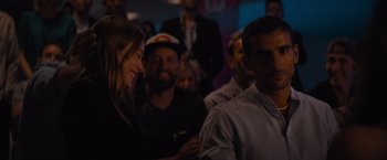 Movie still from “No Limit” (2022), directed by David M. Rosenthal – A group of people sitting in a room; Close Up shot, Over the shoulder angle