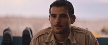 Movie still from “No Limit” (2022), directed by David M. Rosenthal – A person wearing a shirt; Close Up shot, Over the shoulder angle