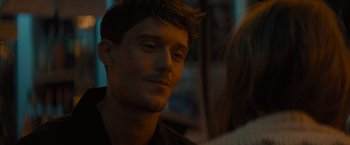 Movie still from “No Limit” (2022), directed by David M. Rosenthal – A person wearing a black shirt; Close Up shot, Over the shoulder angle