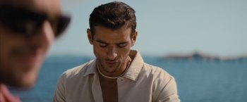 Movie still from “No Limit” (2022), directed by David M. Rosenthal – A person wearing a white shirt; Close Up shot, Over the shoulder angle