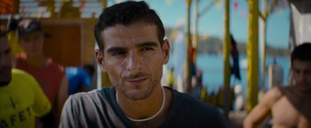 Movie still from “No Limit” (2022), directed by David M. Rosenthal – A man's face in front of a body of water; Close Up shot, Over the shoulder angle