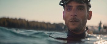 Movie still from “No Limit” (2022), directed by David M. Rosenthal – A person in the water; Close Up shot, Low angle