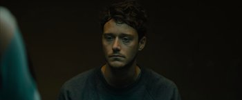 Movie still from “No Limit” (2022), directed by David M. Rosenthal – A person wearing a sweatshirt; Close Up shot, High angle