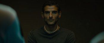 Movie still from “No Limit” (2022), directed by David M. Rosenthal – A person wearing a necklace; Close Up shot, Low angle