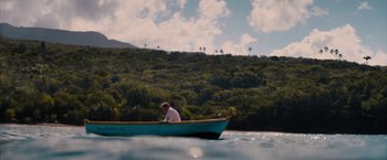 Movie still from “No Limit” (2022), directed by David M. Rosenthal – A person in a boat on a body of water; Extreme Wide shot, High angle
