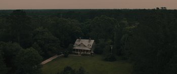 Movie still from “No One Will Save You” (2023), directed by Brian Duffield – An aerial view of a house in the middle of a forest; Extreme Wide shot, High angle