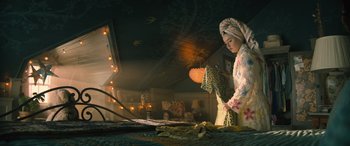 Movie still from “No One Will Save You” (2023), directed by Brian Duffield – A woman in a white dress is holding a umbrella; Medium shot, Low angle