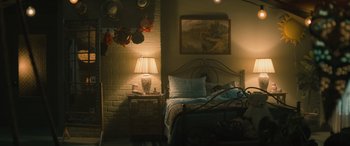 Movie still from “No One Will Save You” (2023), directed by Brian Duffield – A bedroom with a bed , nightstand , and lamp; Wide shot, High angle
