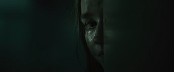 Movie still from “No One Will Save You” (2023), directed by Brian Duffield – A woman with tears in her eyes is looking at the camera; Extreme Close Up shot, Low angle