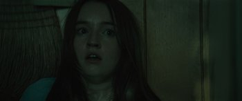 Movie still from “No One Will Save You” (2023), directed by Brian Duffield – A woman with long hair stares into the camera; Close Up shot, Low angle