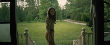 Movie still from “No One Will Save You” (2023), directed by Brian Duffield – A woman standing in a park near a path; Medium shot, High angle