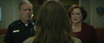 Movie still from “No One Will Save You” (2023), directed by Brian Duffield – Two women and a man are talking to each other; Close Up shot, Over the shoulder angle