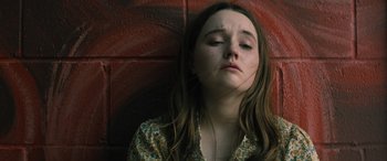 Movie still from “No One Will Save You” (2023), directed by Brian Duffield – A woman with long hair is laying down; Close Up shot, High angle