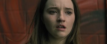 Movie still from “No One Will Save You” (2023), directed by Brian Duffield – A young woman's face; Close Up shot, High angle