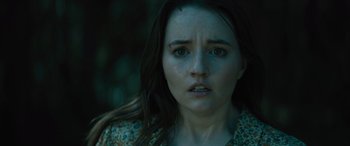 Movie still from “No One Will Save You” (2023), directed by Brian Duffield – A person wearing a floral shirt; Close Up shot, High angle