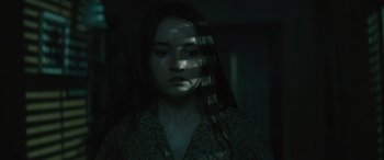 Movie still from “No One Will Save You” (2023), directed by Brian Duffield – A young woman with long black hair stares at the camera; Close Up shot, High angle
