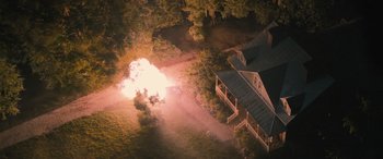 Movie still from “No One Will Save You” (2023), directed by Brian Duffield – An aerial view of a house with a fire coming out of it; Extreme Wide shot, Overhead angle