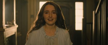 Movie still from “No One Will Save You” (2023), directed by Brian Duffield – A woman with long brown hair wearing a white shirt; Close Up shot, Over the shoulder angle