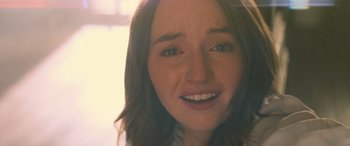 Movie still from “No One Will Save You” (2023), directed by Brian Duffield – A woman's face with brown hair; Close Up shot, Over the shoulder angle