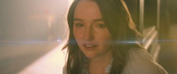 Movie still from “No One Will Save You” (2023), directed by Brian Duffield – A woman's face in the sunlight; Close Up shot, Over the shoulder angle
