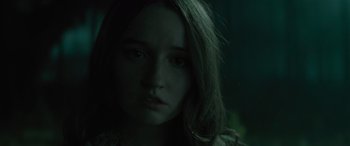 Movie still from “No One Will Save You” (2023), directed by Brian Duffield – A woman with long hair is staring at the camera; Close Up shot, Low angle
