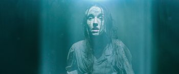 Movie still from “No One Will Save You” (2023), directed by Brian Duffield – A woman with long wet hair is in the water; Medium shot, High angle