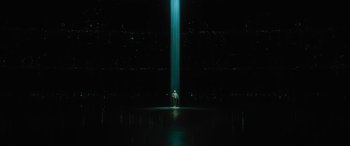 Movie still from “No One Will Save You” (2023), directed by Brian Duffield – A man standing in front of a light in the dark; Extreme Wide shot, Low angle