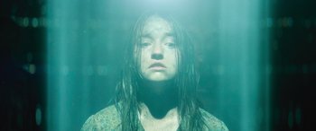Movie still from “No One Will Save You” (2023), directed by Brian Duffield – A woman with wet hair is submerged in a body of water; Close Up shot, High angle
