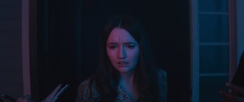 Movie still from “No One Will Save You” (2023), directed by Brian Duffield – A young woman with long dark brown hair; Close Up shot, High angle
