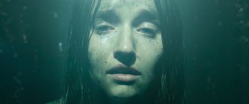 Movie still from “No One Will Save You” (2023), directed by Brian Duffield – A woman's face in the water; Close Up shot, Overhead angle