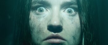 Movie still from “No One Will Save You” (2023), directed by Brian Duffield – A man's face with a lot of dirt on his face; Extreme Close Up shot, Overhead angle
