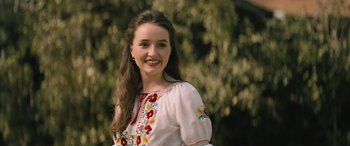 Movie still from “No One Will Save You” (2023), directed by Brian Duffield – A woman in a white shirt with flowers on it; Close Up shot, Over the shoulder angle