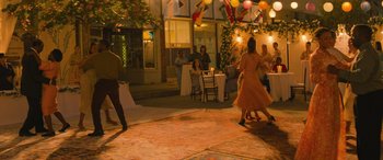 Movie still from “No One Will Save You” (2023), directed by Brian Duffield – A group of people dancing on a sidewalk; Extreme Wide shot, High angle