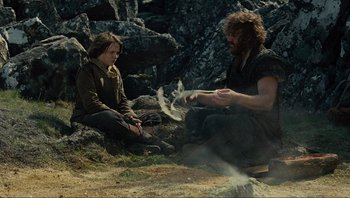 Movie still from “Noah” (2014), directed by Darren Aronofsky – Two people sitting on the ground in a field; Medium shot, Over the shoulder angle