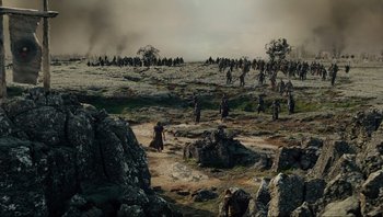 Movie still from “Noah” (2014), directed by Darren Aronofsky – A group of people standing on top of a rocky hill; Extreme Wide shot, High angle