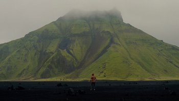 Movie still from “Noah” (2014), directed by Darren Aronofsky – A person standing in front of a large mountain; Extreme Wide shot, High angle