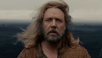 Movie still from “Noah” (2014), directed by Darren Aronofsky – A man with long hair and a beard is looking at the camera; Close Up shot, Low angle