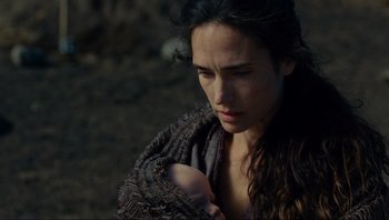 A woman holding a baby in her arms