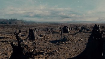 Movie still from “Noah” (2014), directed by Darren Aronofsky – A view of a barren landscape with trees in the foreground; Extreme Wide shot, High angle