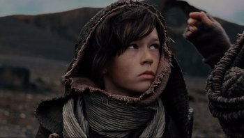 Movie still from “Noah” (2014), directed by Darren Aronofsky – A young person wearing a hooded jacket looking up at the sky; Close Up shot, Low angle