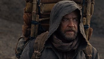 Movie still from “Noah” (2014), directed by Darren Aronofsky – A person wearing a hooded jacket; Close Up shot, Over the shoulder angle
