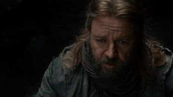 Movie still from “Noah” (2014), directed by Darren Aronofsky – A man with long hair and a beard looking to his left; Close Up shot, Low angle