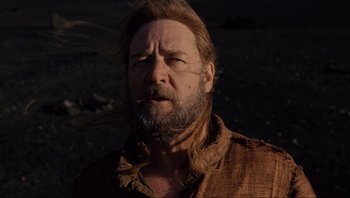 Movie still from “Noah” (2014), directed by Darren Aronofsky – A man with long hair and a beard is standing outside; Close Up shot, Low angle