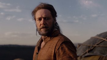Movie still from “Noah” (2014), directed by Darren Aronofsky – A man with long hair and a beard wearing a brown shirt; Medium shot, Low angle